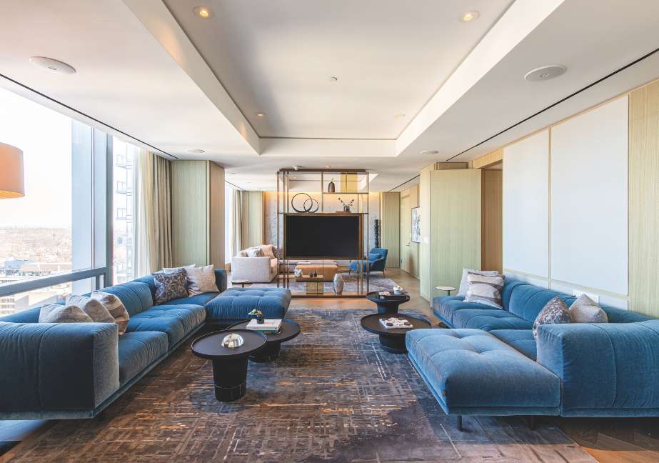 Large room lined on both sides with blue couches.
